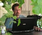 Author Timothy Hallinan working at his computer